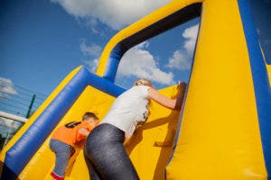 inflatable obstacle course in action, promoting family fitness