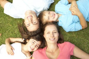 Family lying in the grass